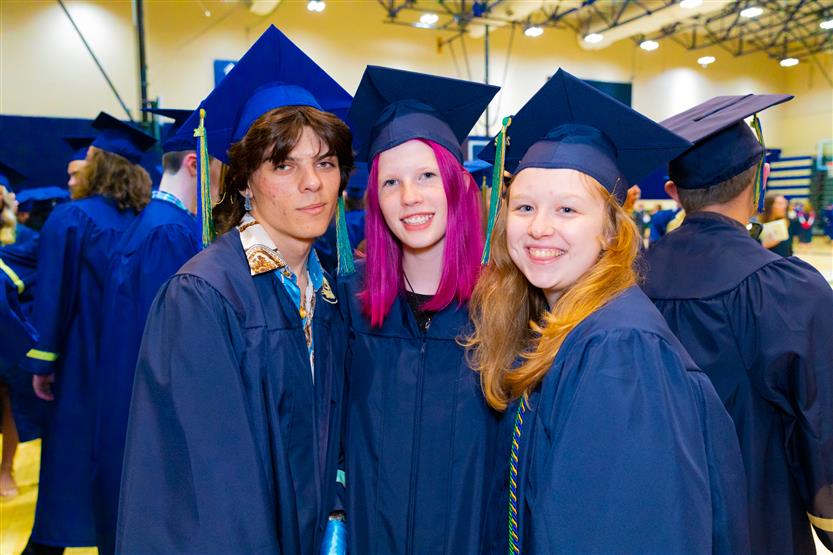 Students wearing blue graduation robes